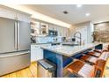 Modern kitchen featuring stainless steel appliances, granite countertops, and a stylish blue island at 920 Memorial Se Dr # 35, Atlanta, GA 30316