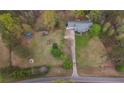 Bird's eye view of the property, surrounded by mature trees, and an expansive yard at 1074 Whooping Creek Rd, Carrollton, GA 30116