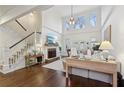 Spacious living room with hardwood floors, stone fireplace, soaring ceilings, staircase and lots of natural light at 1270 Smokehouse Trl, Cumming, GA 30041