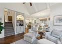 Open concept living space with staircase, built-ins, hardwood floors, and views into the kitchen and dining area at 1270 Smokehouse Trl, Cumming, GA 30041