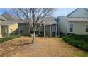 A cozy backyard features green shrubs and a young tree, offering a serene outdoor space at 2675 Sardis Chase Ct, Buford, GA 30519