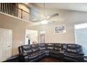 Open-concept living room boasts a cathedral ceiling, a fan and a comfortable, sectional sofa at 2675 Sardis Chase Ct, Buford, GA 30519