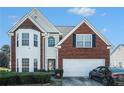 Charming two-story home with a well-maintained lawn and beautiful brick and white siding at 3287 Shady Valley Ln, Loganville, GA 30052