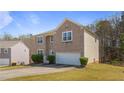 Beautiful home with siding on the side and a two-car garage with green shrubs at 2160 Liberty Hts, Fairburn, GA 30213