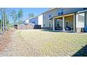 Expansive backyard featuring a covered patio, green grass, and a privacy fence, perfect for outdoor enjoyment at 3489 Central Park Dr, Loganville, GA 30052