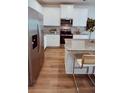 Modern kitchen featuring stainless steel appliances, granite counters, and white cabinetry at 4276 Notting Hill Dr # 23, Atlanta, GA 30331