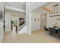 Bright open foyer leads to a formal dining area with luxury vinyl plank flooring and staircase to upper level at 4980 Wildeoak Trl, Douglasville, GA 30135