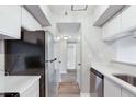 Galley kitchen with stainless steel appliances and white cabinetry at 1 Biscayne Nw Dr # 410, Atlanta, GA 30309