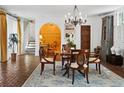 Elegant dining room features a chandelier, arched doorway and beautiful decor at 23 Paces West Dr, Atlanta, GA 30327