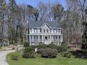 Beautiful two-story home with a charming front porch surrounded by mature trees at 423 Eagle Ridge Trl, Canton, GA 30114