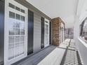 Inviting front porch featuring stone accents, white columns, and charming details at 423 Eagle Ridge Trl, Canton, GA 30114