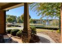 Picturesque view of the neighborhood pond from the front porch with professional landscaping and fountain at 4540 Brighton View Trl, Cumming, GA 30040