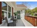 Inviting front porch with seating area and charming green door, perfect for relaxing and enjoying the neighborhood views at 102 Rockyford Ne Rd, Atlanta, GA 30317