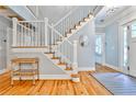 Staircase and entry way with hardwood floors and a modern light fixture at 1658 East Clifton Rd, Atlanta, GA 30307