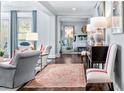 Cozy living room showcasing an inviting space with hardwood floors and access to the bedroom at 2500 Peachtree Nw Rd # 207S, Atlanta, GA 30305