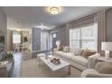 A bright living room showcasing modern decor, including a plush sofa, and a view into the dining area at 2248 Doris Dr, Decatur, GA 30034