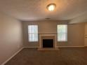 Inviting living area featuring plush carpeting and a cozy fireplace at 1374 To Lani Farm Rd, Stone Mountain, GA 30083