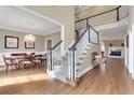 Bright interior showcasing a staircase, dining area with chandelier, and a living room with fireplace at 2930 Monticello Dr, Cumming, GA 30041