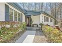 Welcoming front porch with a decorative door, stone walkway, and charming landscaping at 2650 Ridge Valley Nw Rd, Atlanta, GA 30327