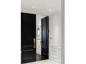 Elegant entrance showcasing black double doors with gold hardware and white trim at 2660 Peachtree Nw Rd # 26F, Atlanta, GA 30305