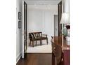 Chic hallway with dark wood floors, paneled walls, and stylish decor at 2660 Peachtree Nw Rd # 26F, Atlanta, GA 30305