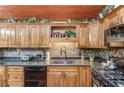 Well-appointed kitchen with granite counters, wood cabinets, and mosaic tile backsplash at 5494 Princeton Oaks Ln, Sugar Hill, GA 30518