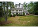 Classic colonial home with lush green lawn and mature trees, offering a serene setting at 240 Pinebrook Way, Roswell, GA 30076