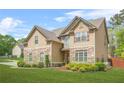 Charming home featuring a combination of stone and siding, complemented by a lush green lawn at 5143 Olive Branch Cir, Powder Springs, GA 30127