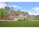 Two-story home featuring stone accents, attached garage, well-manicured lawn, and inviting curb appeal at 5143 Olive Branch Cir, Powder Springs, GA 30127