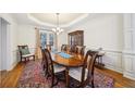 Elegant dining room with hardwood floors, wainscoting, and large wooden table perfect for gatherings at 5300 Cottage Farm Rd, Johns Creek, GA 30022