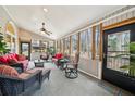 Relaxing sunroom with vaulted ceiling, lots of natural light, and comfortable seating arrangements at 5300 Cottage Farm Rd, Johns Creek, GA 30022