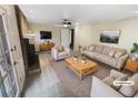 Bright living room is virtually staged with neutral furniture and a brick fireplace at 724 Dukehart Ct, Stone Mountain, GA 30083