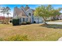 Beautiful home exterior with a manicured lawn, mature trees, and a two-car garage, exuding suburban charm at 2445 Ridgelake Dr, Villa Rica, GA 30180
