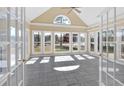 Bright sun room with many windows, tiled flooring, ceiling fan, and views of a beautiful lake at 2445 Ridgelake Dr, Villa Rica, GA 30180