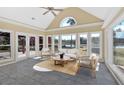 Bright sunroom with large windows overlooking the landscaped backyard and lake at 2445 Ridgelake Dr, Villa Rica, GA 30180