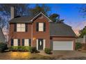 Beautiful two-story brick home with an attached two-car garage and trimmed hedges at 4342 Richmond Nw Pl, Acworth, GA 30101