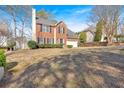 Two-story home with well-manicured lawn, attached garage, and classic brick facade at 4342 Richmond Nw Pl, Acworth, GA 30101