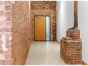 Hallway featuring brick walls and a wooden door with a glass side panel at 490 Marietta Nw St # 105, Atlanta, GA 30313