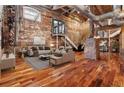 Spacious industrial-style living room with exposed brick, ductwork, and an open floor plan at 490 Marietta Nw St # 105, Atlanta, GA 30313