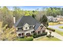 Attractive suburban home featuring a manicured front lawn and a mix of brick and siding at 500 Poplar Creek Xing, Canton, GA 30114