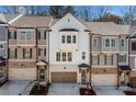 Charming townhome exterior features brick accents, a garage, and a welcoming front entrance with a wreath at 234 Retreat Ln, Canton, GA 30114