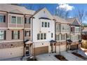 New townhome exteriors featuring brick accents, individual garages, and manicured landscaping at 234 Retreat Ln, Canton, GA 30114