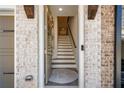 Bright foyer features a staircase and painted brick accent wall at 234 Retreat Ln, Canton, GA 30114