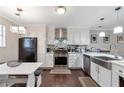 Modern kitchen with white cabinets, stainless steel appliances, and a stylish backsplash at 241 Quail Run, Roswell, GA 30076
