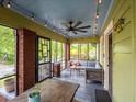 Spacious screened front porch with ceiling fan, outdoor seating, and string lights at 646 Catherine Sw St, Atlanta, GA 30310