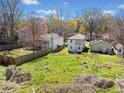 Backyard aerial view, showing fence, green grass and the exterior of this updated home at 92 Ormond Se St, Atlanta, GA 30315
