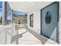 Charming front porch with white brick and railing, leading to a light blue door with an oval window at 92 Ormond Se St, Atlanta, GA 30315