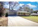 Beautiful ranch-style home with a spacious driveway and attached carport at 1295 Maple St Se, Conyers, GA 30013