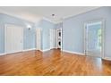 The bedroom features hardwood floors, light blue walls, and an in-unit washer and dryer at 140 Alden Nw Ave # 201, Atlanta, GA 30309