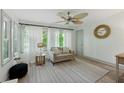 Bright living room with ample natural light, neutral tones, ceiling fan, and hardwood floors throughout the space at 178 Barone Nw Pl, Atlanta, GA 30327